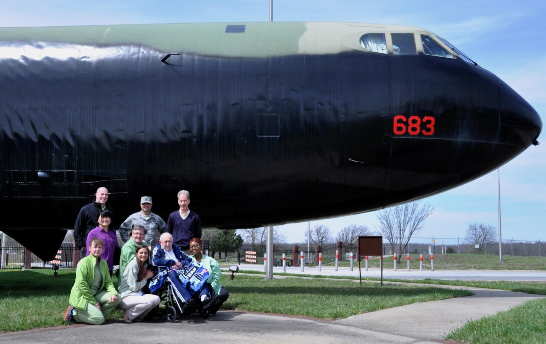 Retired U.S. Air Force Capt. Kenneth Rogers, his family and hospice team smile in front of a static B-52 Stratofortress on March 29, 2016, at Whiteman Air Force Base. Rogers was a B-52 navigator. 