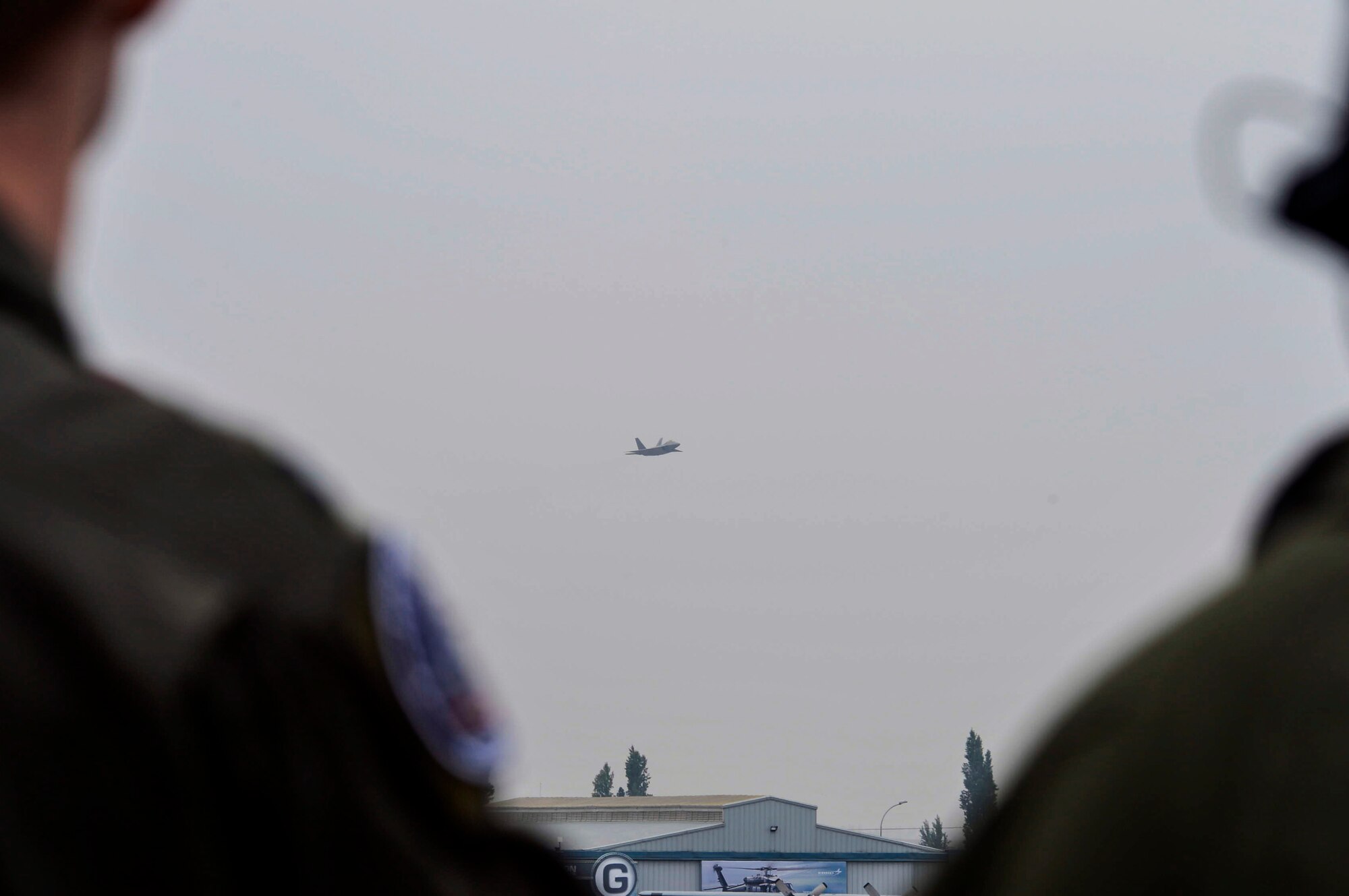 Members from the F-22 Raptor Demonstration Team, from Langley AFB, Va., watch the Raptor’s aerial acrobatics routine at the 2016 International Air and Space Fair (FIDAE) in Santiago, Chile, April 2, 2016. During FIDAE, U.S. Airmen participated in in several subject matter expert exchanges with their Chilean counterparts and also hosted static displays and aerial demonstrations to support the air show.  (U.S. Air Force photo by Tech. Sgt. Heather Redman/Released)