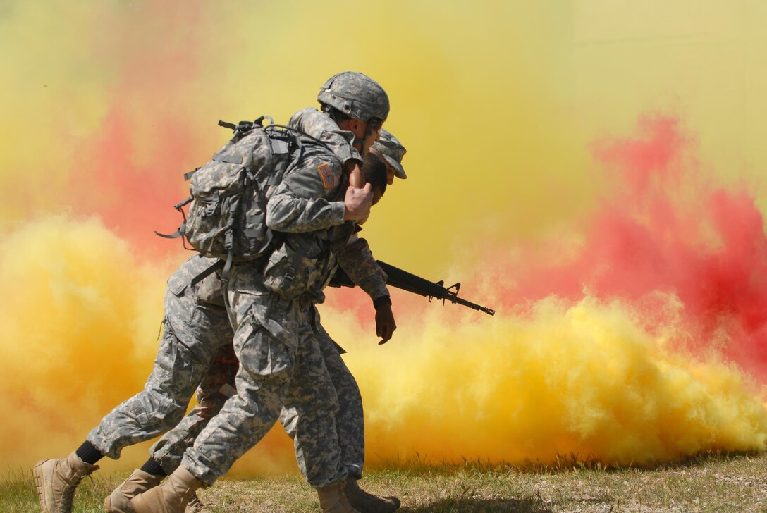 Spc. Nicholas Ladolcetta, a soldier with the 151st Theater Information Operations Group evacuates a casualty during the tactical combat casualty care lane at the U.S. Army Civil Affairs and Psychological Operations Command (Airborne) Best Warrior Competition at Fort Hunter Liggett, Calif. April 4, 2016. The winner of the competition moves on to represent the command at the U.S. Army Reserve Command Best Warrior Competition later this year. (U.S. Army photo by Capt. James Orth, 351st CACOM)