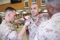 Tucson, Ariz.-Native Luis A. Ochoa, an embarker with Chemical Biological Incident Response Force is promoted to the rank of staff sergeant during a ceremony at Chemical Biological Incident Response Force (CBIRF) headquarters aboard Naval Support Facility Indian Head, Md., April 4, 2016. When directed, CBIRF forward-deploys and/or responds with minimal warning to a chemical, biological, radiological, nuclear and high yield explosive (CBRNE) threat or event in order to assist local, state, or federal agencies and the geographic combatant commanders in the conduct of CBRNE response or consequence management operations, providing capabilities for command and control; agent detection and identification; search, rescue, and decontamination; and emergency medical care for contaminated personnel. (Official USMC Photos by Sgt. Jonathan Herrera)