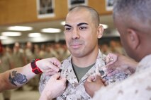 Tucson, Ariz.-Native Luis A. Ochoa, an embarker with Chemical Biological Incident Response Force is promoted to the rank of staff sergeant during a ceremony at Chemical Biological Incident Response Force (CBIRF) headquarters aboard Naval Support Facility Indian Head, Md., April 4, 2016. When directed, CBIRF forward-deploys and/or responds with minimal warning to a chemical, biological, radiological, nuclear and high yield explosive (CBRNE) threat or event in order to assist local, state, or federal agencies and the geographic combatant commanders in the conduct of CBRNE response or consequence management operations, providing capabilities for command and control; agent detection and identification; search, rescue, and decontamination; and emergency medical care for contaminated personnel. (Official USMC Photos by Sgt. Jonathan Herrera)