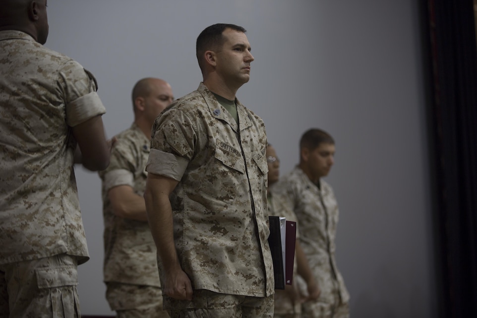 Gunnery Sgt. Alan Crittenden, communications chief, 3rd Marine Division, stands in front of his classmates as he is recognized as the honor graduate of  the Communications Chief Course 1-16 during the course’s graduation ceremony at the base theater April 1, 2016. (Official Marine Corps Photo by Cpl. Julio McGraw/Released)