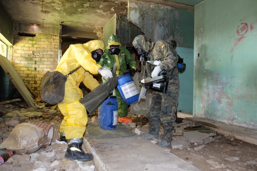 A combined assessment team was made up of two Spanish Army Recon Regt. Soldiers, one Spanish Emergency Military Unit member and U.S. Army Staff Sgt. Shawn McKenna, from the 7th Mission Support Command’s 773rd Civil Support Team, center, conduct a site assessment of a suspected chemical spill site inside an abandoned building spray painted with murals of graffiti and littered with brick, concrete and debris, Apr. 5, 2016.  U.S. Army Reserve Soldiers from the 7th MSC conducted combined joint partnered foreign consequence management disaster response operations with personnel from U.S. Navy Combined Joint Task Force 68 as part of more than 100 military members and civilians as part of the Combined Joint Task Force-Foreign Consequence Management or CJTF-FCM in support of the Spanish Emergency Military Unit first responders  or UME and Spanish Army Recon during disaster emergency response exercise Combined Joint Exercise SUR 2016.
