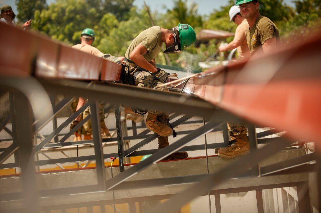 Marine Corps Lance Cpl. Marco Rodriguez, an engineer assigned to the 9th Engineer Support Battalion, welds and prepares metal framing, April 2, 2016, at San Nicolas Elementary School in Capiz, Philippines, as part of a humanitarian civic assistance project during Exercise Balikatan 2016. The construction project is one of several taking place during this year's exercise. Marine Corps photo by Cpl. Hilda M. Becerra