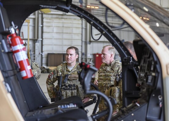 Chief Master Sgt. of the Air Force James A. Cody and Tech. Sgt. Daniel Bogan, a rotary wing gun air advisor, listen as a train, advise and assist pilot discusses Afghan air force progress with the MD-530 light attack helicopter at Hamid Karzai International Airport, Afghanistan, April 6, 2016. During his trip, Cody engaged with Airmen deployed to Afghanistan in support of the NATO Resolute Support mission and Operation Freedom’s Sentinel through a series of question-and-answer all calls, small group discussions and personal site visits. (U.S. Air Force photo/Tech. Sgt. Nicholas Rau)