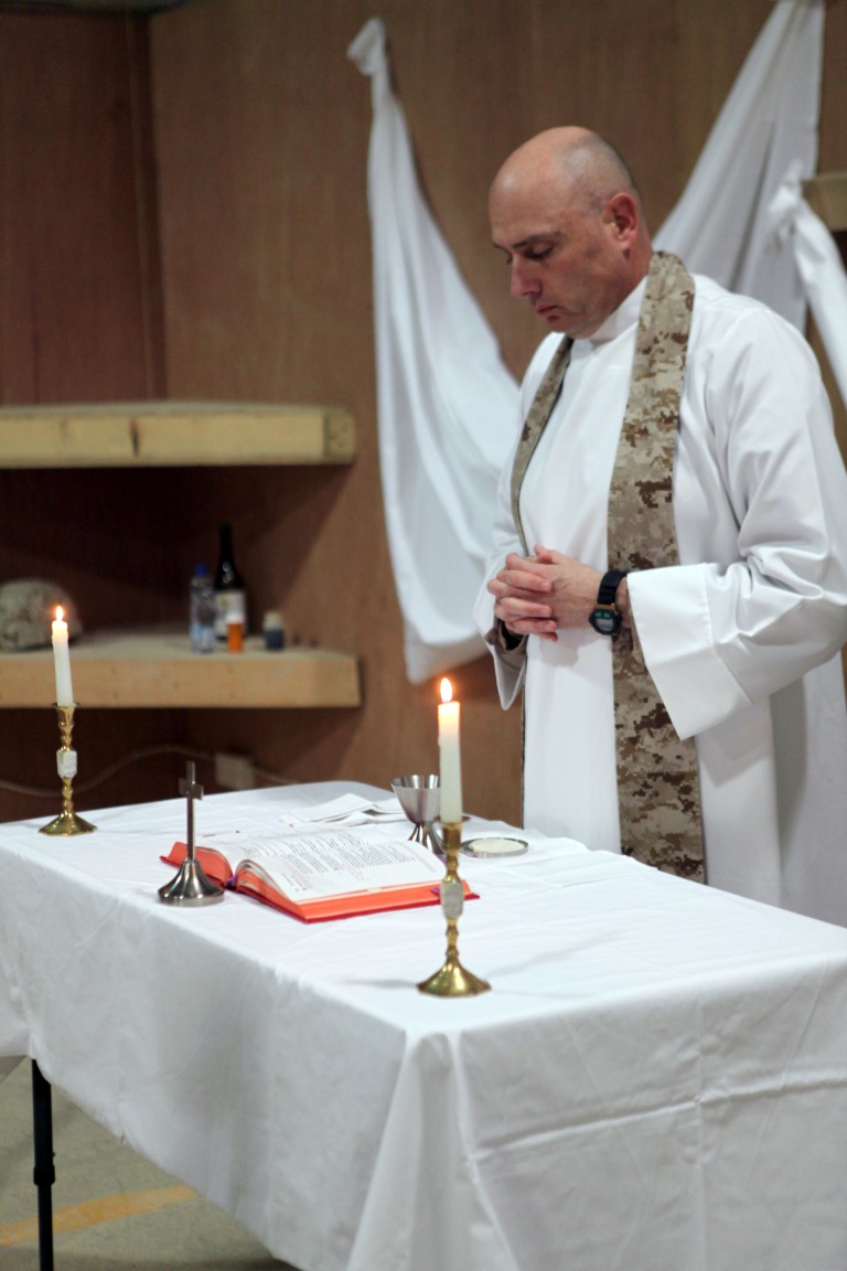 U.S. Navy Cmdr. Christopher Fronk, the command chaplain of the USS George H W Bush (CVN 77), and a catholic priest, conducts Easter Mass for Catholic troops in Al Asad Air Base, Iraq, March 24, 2016. Fronk traveled twice from Norfolk, Virginia, during Christmas and Easter, to serve catholic troops currently deployed in support of Operation Inherent Resolve in Al Asad and Al Taqaddum Air Bases in Iraq. (U.S. Army Photo by SGT. Joshua Powell / Released).