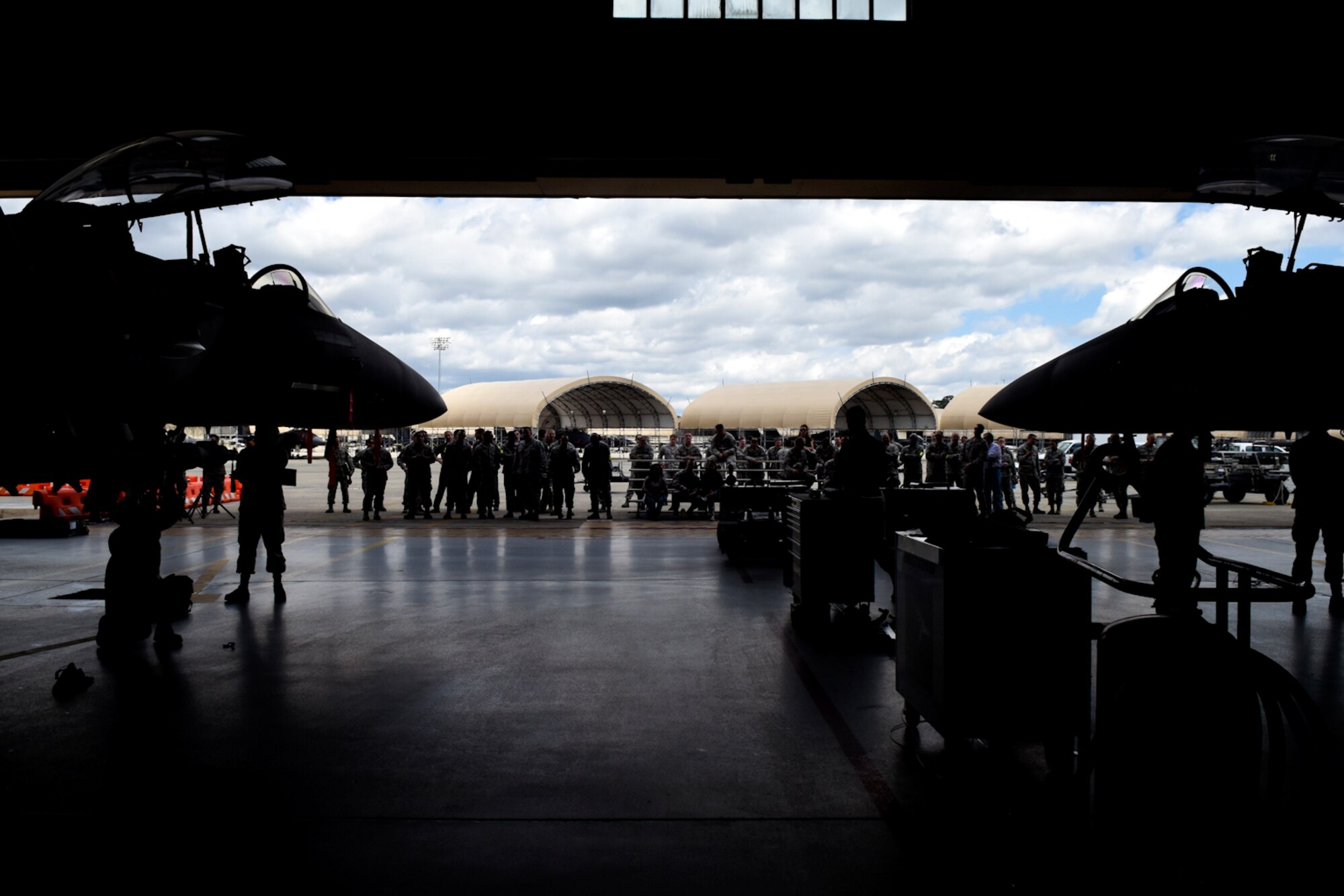 Members of Team Seymour watch as Airmen assigned to the 4th Aircraft Maintenance Squadron compete against each other in a Load Crew of the Quarter competition, April 7, 2016, at Seymour Johnson Air Force Base, North Carolina. More than 30 Airmen came to watch and cheer on their respective teams during the competition. (U.S. Air Force photo/Airman Shawna L. Keyes)
