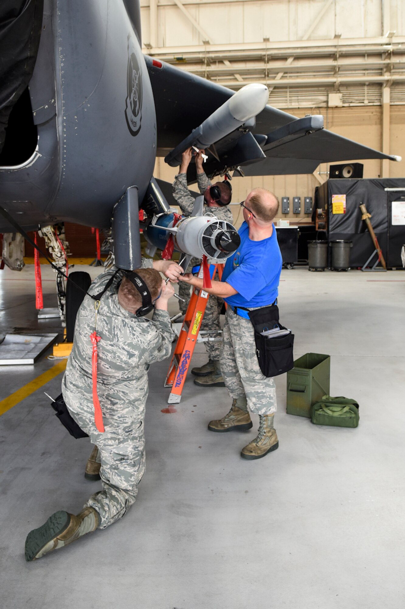 Airmen from the 4th Aircraft Maintenance Squadron representing the 334th Aircraft Maintenance Unit load a weapon onto an F-15E Strike Eagle aircraft during a Load Crew of the Quarter competition, April 7, 2016, at Seymour Johnson Air Force Base, North Carolina. Crews from two different AMUs competed against each other for the best time while ensuring accuracy, serviceability and efficiency, and to earn bragging rights. (U.S. Air Force photo/Airman Shawna L. Keyes)