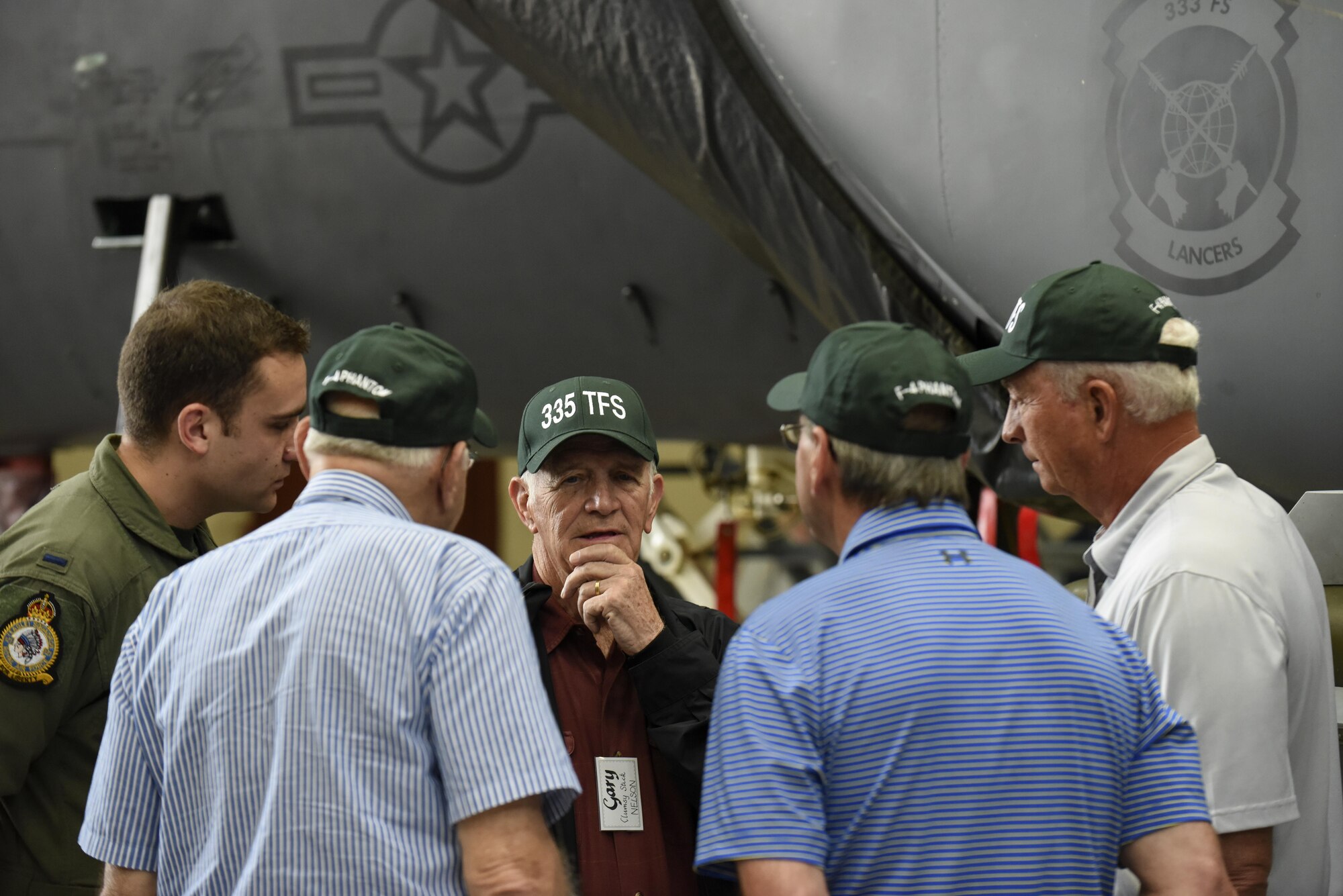 A group of former 335th Tactical Fighter Squadron and current 335th Fighter Squadron members share stories about their service, April 1, 2016, at Seymour Johnson Air Force Base, North Carolina. Members of the 335th FS opened their doors to the combat veterans, to learn about their experiences and time in the Air Force. (U.S. Air Force photo/Airman 1st Class Aaron J. Jenne)