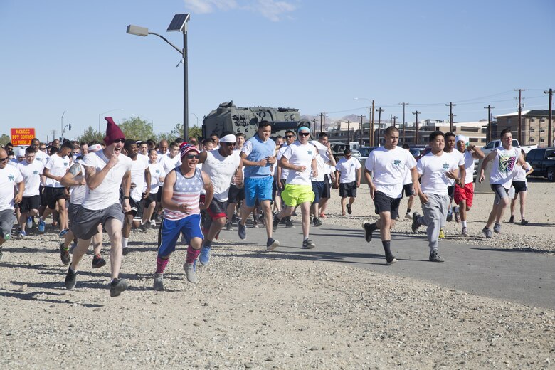 Participants take off from the start of the Sexual Assault Prevention and Response annual Colorful Consent 5k Run held aboard the Combat Center, April 1, 2016. (Official Marine Corps photo by Cpl. Thomas Mudd/Released)