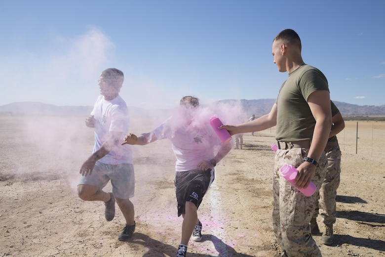 Marines throw colored powder onto participants of the Sexual Assault Prevention and Response annual Colorful Consent 5k Run held aboard the Combat Center, April 1, 2016. (Official Marine Corps photo by Cpl. Thomas Mudd/Released)