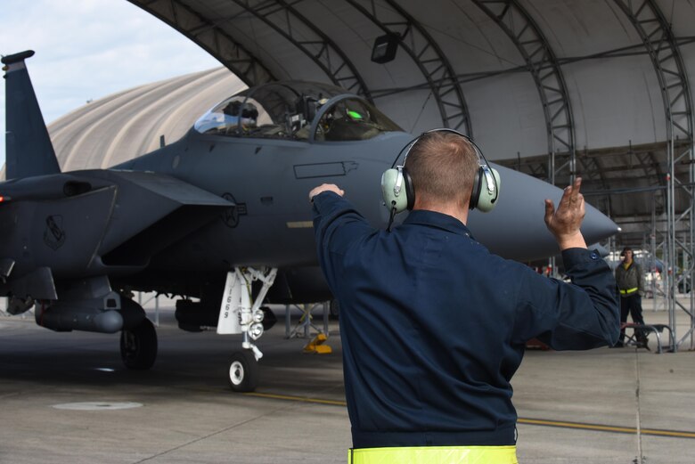 Senior Airman James Hurt, 4th Aircraft Maintenance Squadron crew chief, marshals an F-15E Strike Eagle aircraft during Razor Talon, April 8, 2016, at Seymour Johnson Air Force Base, North Carolina. Razor Talon is a Seymour Johnson AFB, home-grown initiative that partners units along the East Coast in an effort to promote the air-sea battle concept. (U.S. Air Force photo/ Senior Airman Aaron J. Jenne)