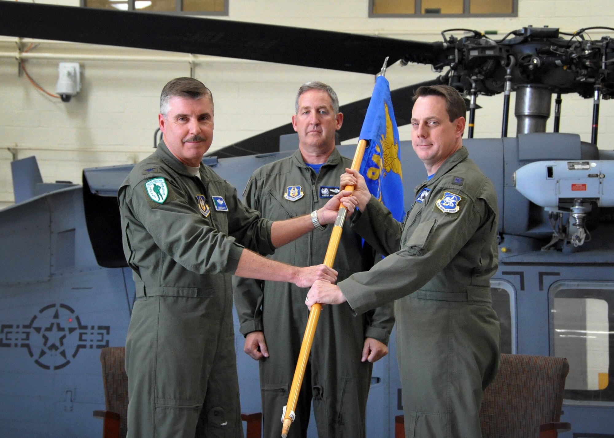 U.S. Air Force Reserve Lt. Col. Andrew Meshel, who formerly served as the 943rd Rescue Group deputy commander, accepts the 305th Rescue Squadron guidon from Col. John Beatty, the group commander, during an assumption of command ceremony at Davis-Monthan Air Force Base, Ariz., April 3.
