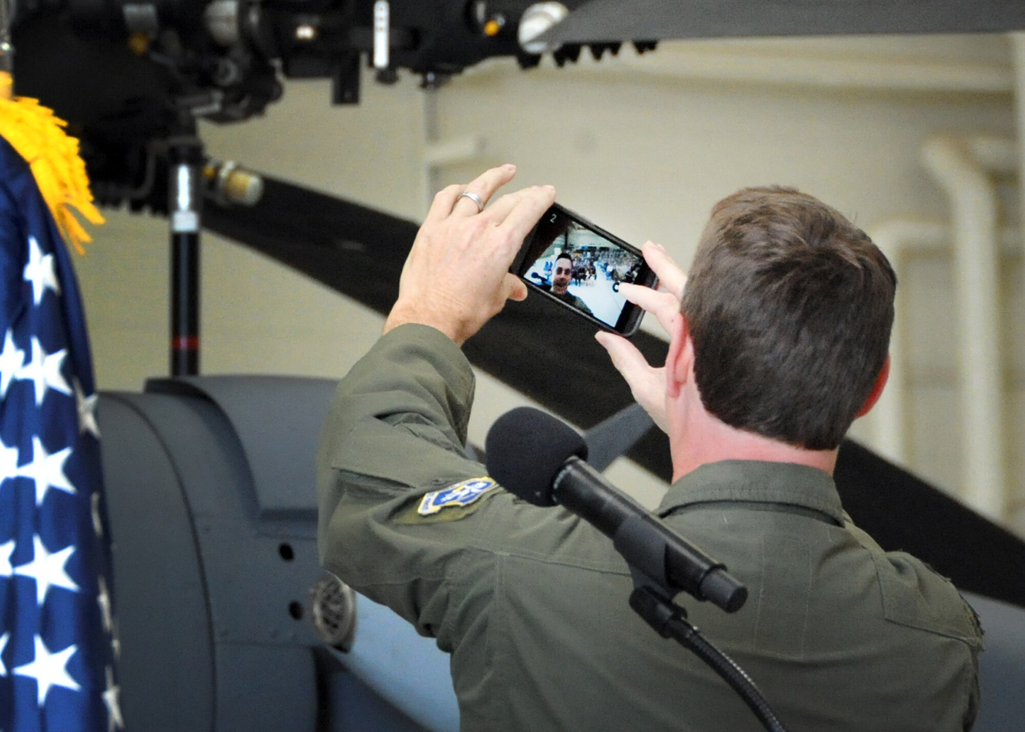 Lt. Col. Andrew Meshel, the newly-appointed 305th Rescue Squadron commander, snaps a selfie with the unit during the assumption of command ceremony at the 943rd Maintenance Squadron hangar at Davis-Monthan Air Force Base, Ariz., April 3. (U.S. Air Force photo/Tech. Sgt. Carolyn Herrick)