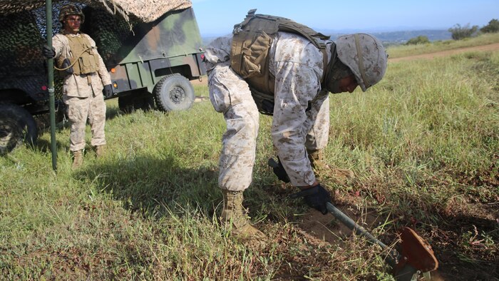 Marines with Battery Q, 5th Battalion, 11th Marine Regiment, I Marine Expeditionary Force, set up camouflage netting during Spring Fire Exercise at Marine Corps Base Camp Pendleton March 31, 2016. During the combined-arms training evolution, each battalion moved to different locations on a frequent basis in order to simulate positions they would hold based on specific situations, setting up and breaking down their outposts as quickly as possible.