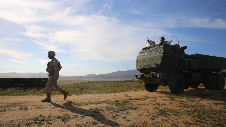A Marine with Battery Q, 5th Battalion, 11th Marine Regiment, I Marine Expeditionary Force, guides a High Mobility Artillery Rocket System launcher during Spring Fire Exercise at Marine Corps Base Camp Pendleton March 31, 2016. The regiment, comprised of four artillery battalions and a headquarters battalion, put their skills to the test during a large-scale, combined-arms training evolution in preparation for future deployments and operations. 
