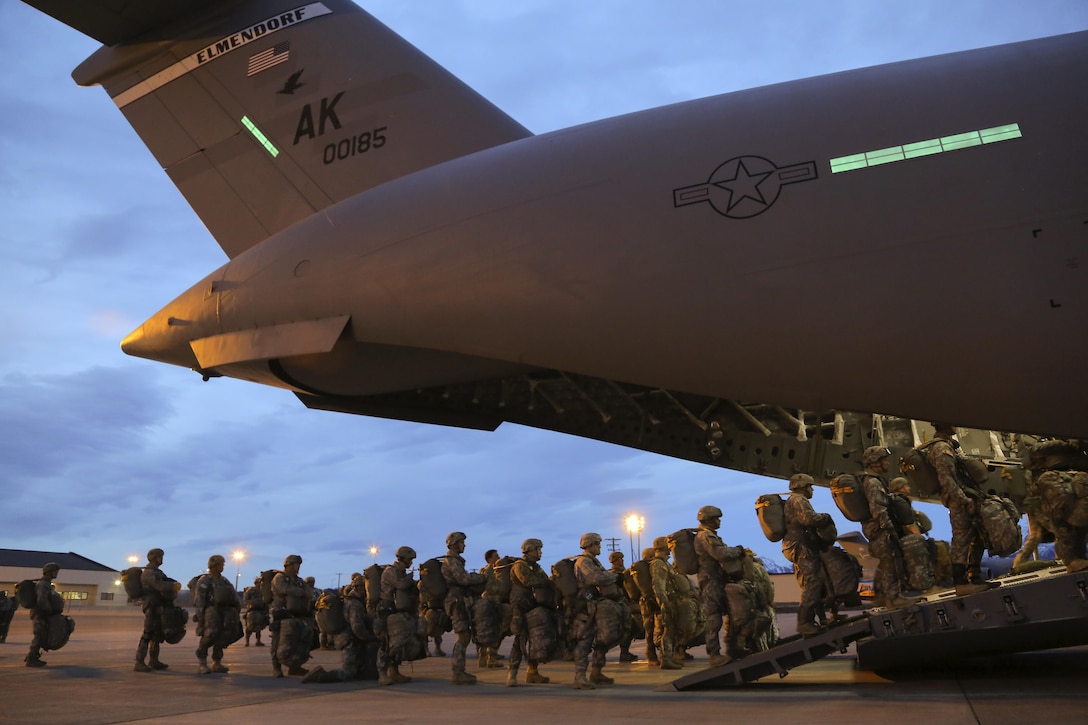 Paratroopers walk up the back ramp of an Air Force C-17 Globemaster III aircraft before participating in a night jump at Joint Base Elmendorf-Richardson, Alaska, March 31, 2016. Air Force photo by Alejandro Pena