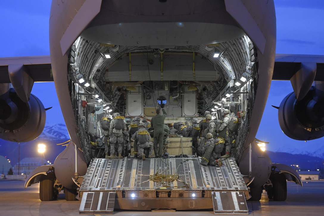 Paratroopers position their gear inside an Air Force C-17 Globemaster III aircraft before participating in a night jump at Joint Base Elmendorf-Richardson, Alaska, March 31, 2016. Air Force photo by Alejandro Pena