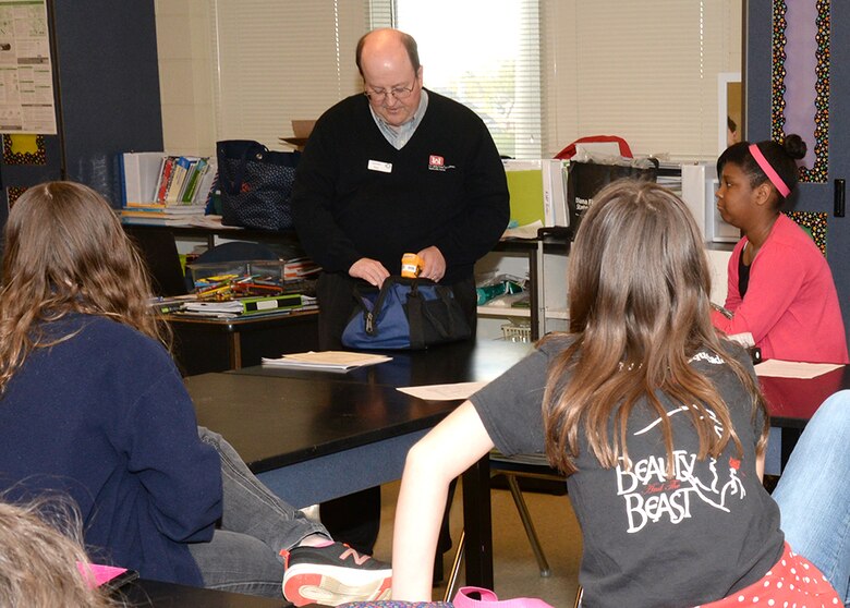 Jerry Henley, a U.S. Army Engineering and Support Center Huntsville electrical engineer, shows Ms. Smith's fifth and sixth grade Science, Technology, Engineering and Math lab students some tools he uses to do his job during Mill Creek Elementary School's career day April 8.