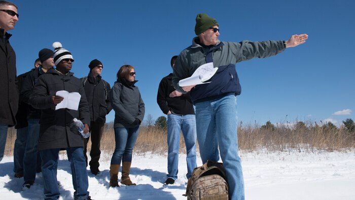 Col. Jason Bohm, the director of the school makes  a short stop to talk about the terrain of the battlefield and about what kind of tactics the officers of the Revolutionary War used during their trip to Saratoga Springs, New York on April 5, 2016. The Marines talked about tactics such as reverse slope defense versus forward slope defense, and cover versus concealment.