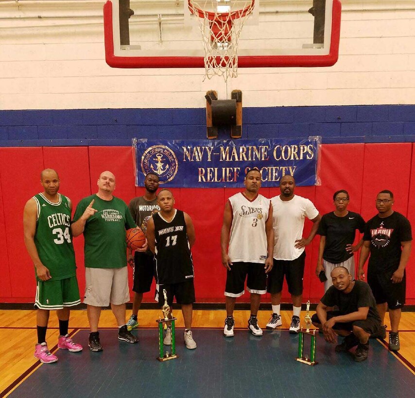 Eight teams participate in a 3-on-3 basketball tournament at Marine Corps Logistics Base Albany’s Thomason Gym, recently. The event was one of three activities held on the installation to raise money during the Navy-Marine Corps Relief Society’s Fund Drive. Maj. Lee Taylor (fourth from left) and his four-man team walked away undefeated, with the 1st place trophy and Ball is Life’s five-man team won the 2nd place trophy.