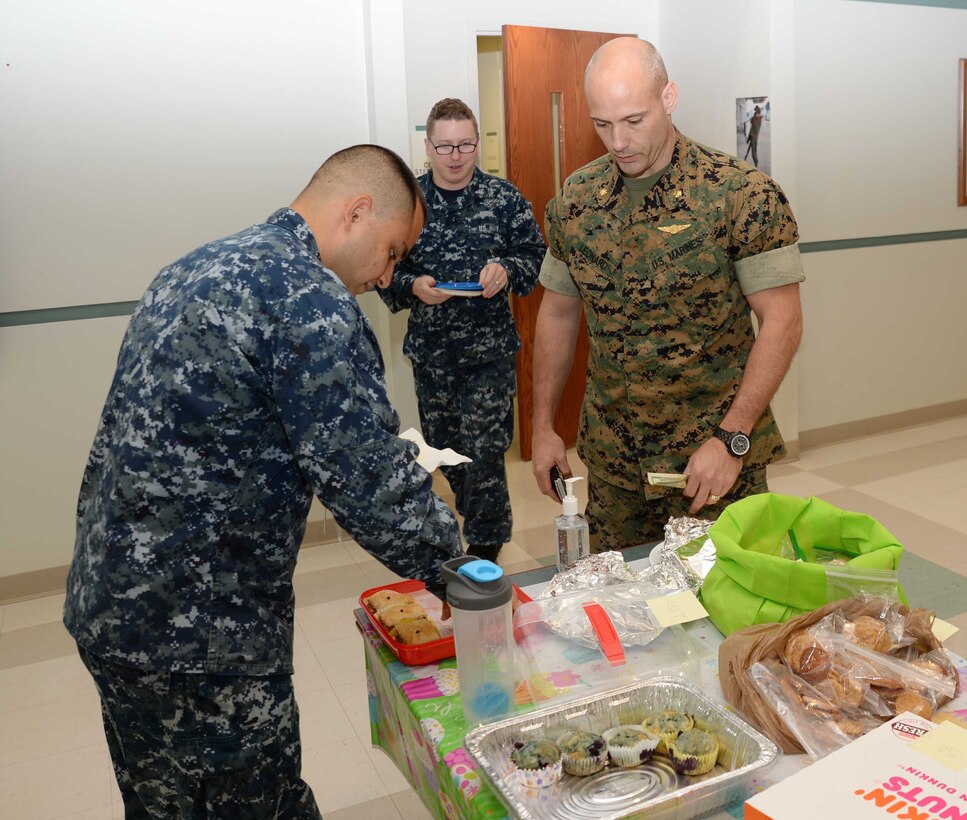 Maj. Timothy Leonard (right), operations research analyst, Marine Corps Logistics Command, purchases baklava from Petty Officer 3rd Class Louis Amaya Sanchez at a bake sale, recently. The event, which was held at Naval Branch Health Clinic-Albany, was the final of three activities organized at Marine Corps Logistics Base Albany to raise money during the Navy-Marine Corps Relief Society’s Fund Drive. Amaya, a laboratory technician, NBHC-Albany, is the clinic’s NMCRS representative/point of contact for the fund drive.