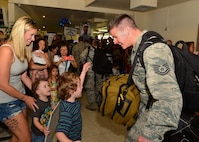 A Tech. Sgt. from the 154th Aircraft Maintenance Squadron greets his family after returning from a six-month deployment , on Joint Base Pearl Harbor-Hickam, , April 5, 2016.(U.S. Air Force photo by Tech. Sgt. Aaron Oelrich/released) 