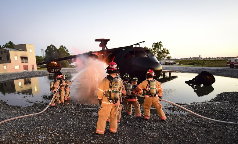 Firefighters with the 1st Special Operations Civil Engineer Squadron extinguish a fire during a firefighting exercise at Hurlburt Field, Fla., April 5, 2016.  During the exercise firefighters tested their proficiency on extinguishing exterior and interior fires on a simulated C-130 aircraft. (U.S. Air Force photo by Staff Sgt. Christopher Callaway)