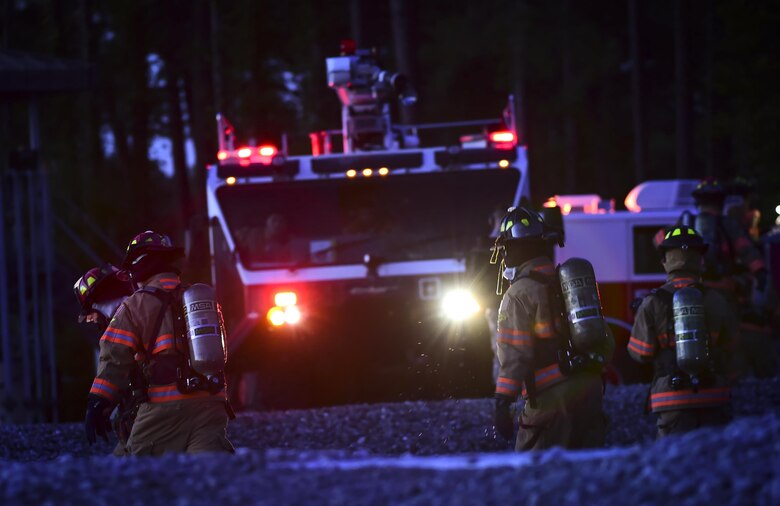 Firefighters with the 1st Special Operations Civil Engineer Squadron wrap up a firefighting exercise at Hurlburt Field, Fla., April 5, 2016.  During the exercise firefighters tested their proficiency on extinguishing exterior and interior fires on a simulated C-130 aircraft. (U.S. Air Force photo by Staff Sgt. Christopher Callaway)