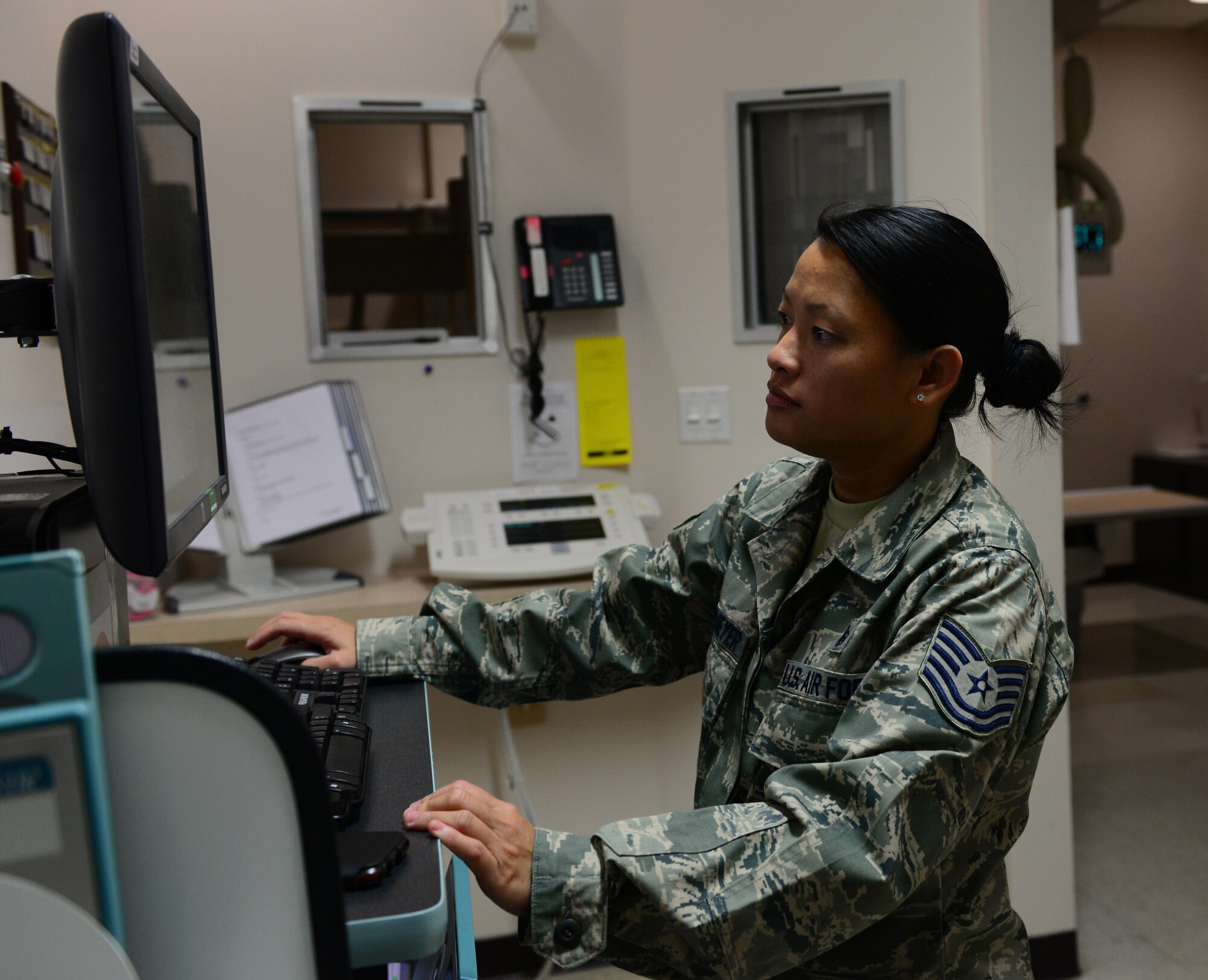 U.S Air Force Tech. Sgt. Mia Newmeyer, the 354th Medical Group Diagnostics and Therapeutics flight chief, reviews an x-ray April 6, 2016, at Eielson Air Force Base, Alaska. Newmeyer checks for proper positioning, exposure and to determine if another x-ray is required. (U.S. Air Force photo by Airman 1st Class Cassandra Whitman/Released)