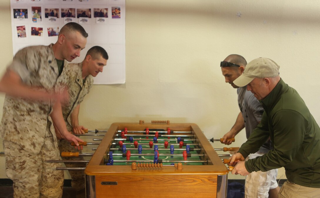 Marines and educators from recruiting stations Lansing, Mich., and Twin Cities, Minn., play foosball at the Great Escape during an Educators Workshop aboard Marine Corps Air Station Miramar, Calif., April 6. Educators visited MCAS Miramar to learn about the aviation side of the Marine Corps and life for a Marine after basic training.