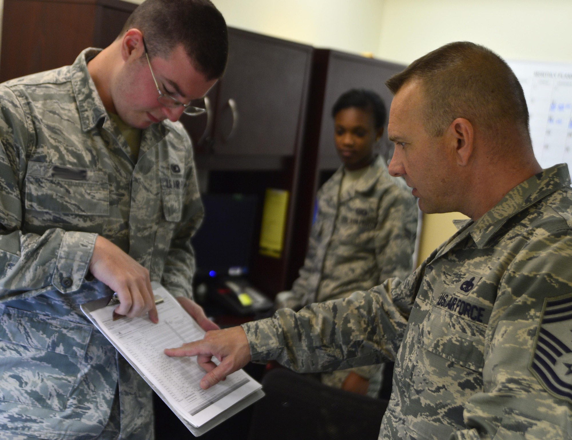 Senior Airman John, 22nd Reconnaissance Squadron squadron aviation resource management (SARM), explains SARM procedures to Chief Master Sgt. Michael Ditore, 432nd Wing/432nd Air Expeditionary Wing command chief, March 23, 2016 at Creech Air Force Base, Nevada. The chief learned about the ‘nitty gritty’ details of the Airmen’s jobs while ensuring the Airmen understood how important they are to the mission and the nation’s security. (U.S. Air Force photo by Senior Airman Christian Clausen/Released)