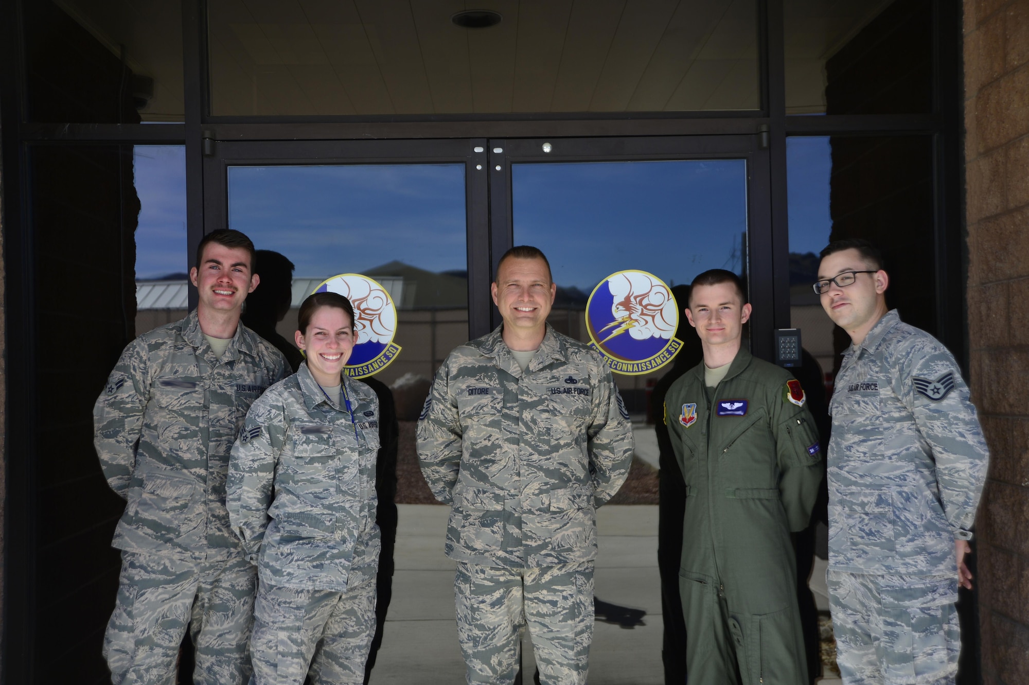 Chief Master Sgt. Michael Ditore, 432nd Wing/432nd Air Expeditionary Wing command chief poses for a photo with Airmen from the 22nd Reconnaissance Squadron March 23, 2016, at Creech Air Force Base, Nevada. The 22nd Reconnaissance Squadron employs Total Force MQ-1/B Predator and MQ-9 Reaper aircrew, and supporting Overseas Contingency Operations worldwide. (U.S. Air Force photo by Senior Airman Christian Clausen/Released)
