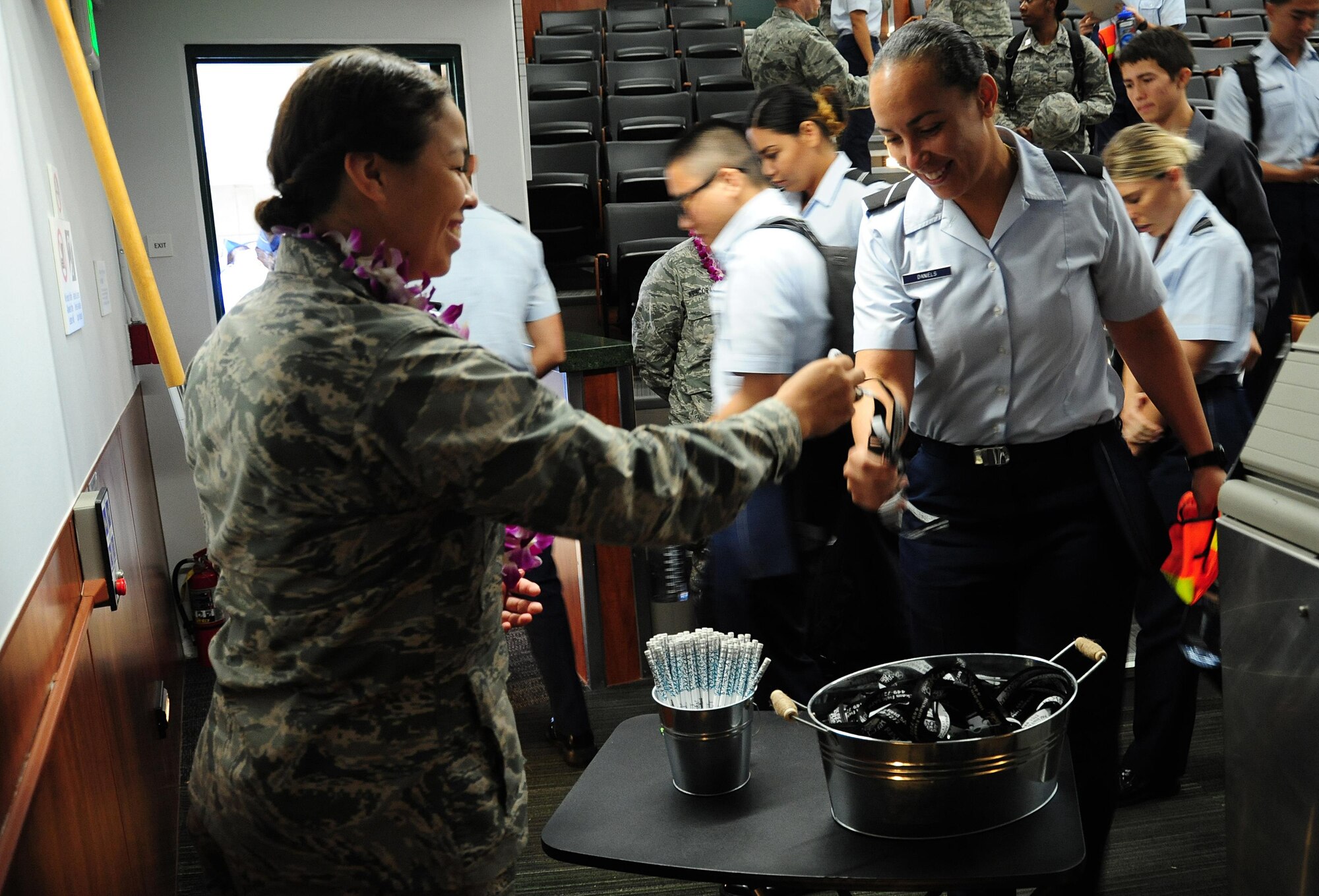2nd Lt. Allyssa Schimmoeller, 15th Wing alternative Sexual Assault Response coordinator, offers Air Force Reserve Officer Training Corps cadets of Detachment 175 Sexual Assault Awareness and Prevention Month tokens after a documentary viewing and discussion at The University of Hawaii, April 7, 2016. The cadets watched the 2015 documentary "The Hunting Ground," and talked about the realities of sexual assault on college campuses and in the military. (U.S. Air Force photo by 2nd Lt. Kaitlin Daddona/Released)