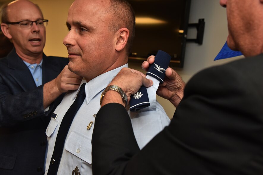 The commander of the 45th Aeromedical Evacuation Squadron, James Palmisano, promotes to the rank of Colonel during his promotion ceremony April 2, 2016, at MacDill Air Force Base. Col. Bill Rolocut, 927th Operations Group, commander, explained how not surprised he was when he was notified of Palmisano’s promotion. “When the promotion list was released, I knew if his name was not on the list, no one had a shot,” said Rolocut. “He is more than deserving of commanding this unit and the promotion to Colonel!” (U.S. Air Force photoby Staff Sgt. Adam C. Borgman)