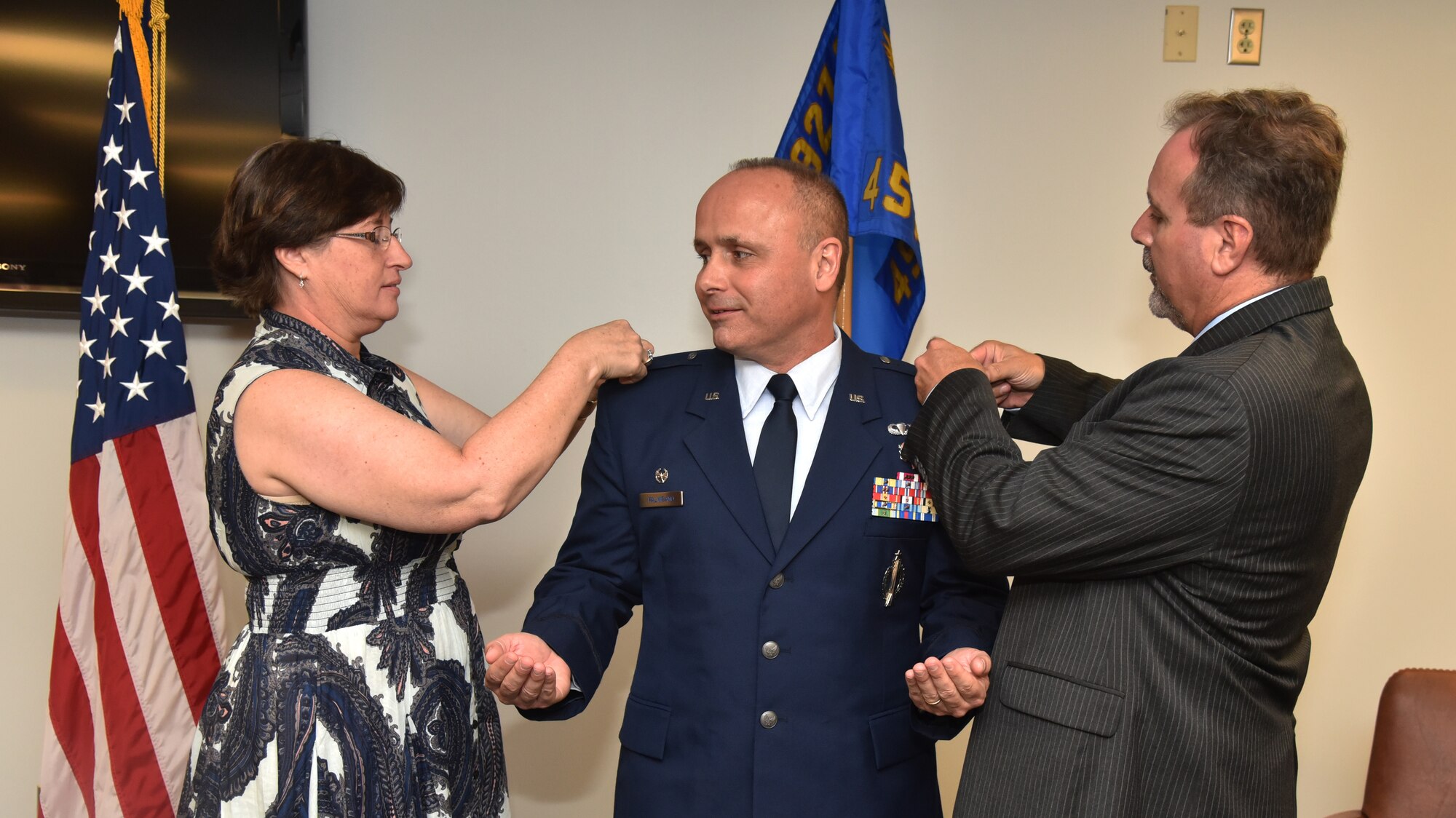 Commander of the 45th Aeromedical Evacuation Squadron gets his new rank of Colonel pinned on by his wife and long term friend and mentor during his promotion ceremony April 2, 2016 at MacDill Air Force Base, Fla. Col. Palmisano credits his promotion to the support from his wife, who he said even when deployed, they are always together. When a deployment is tasked Palmisano said his wife tells him to focus on his unit and she will handle everything needed in the home. (U.S. Air Force photo by Staff Sgt. Adam C. Borgman)