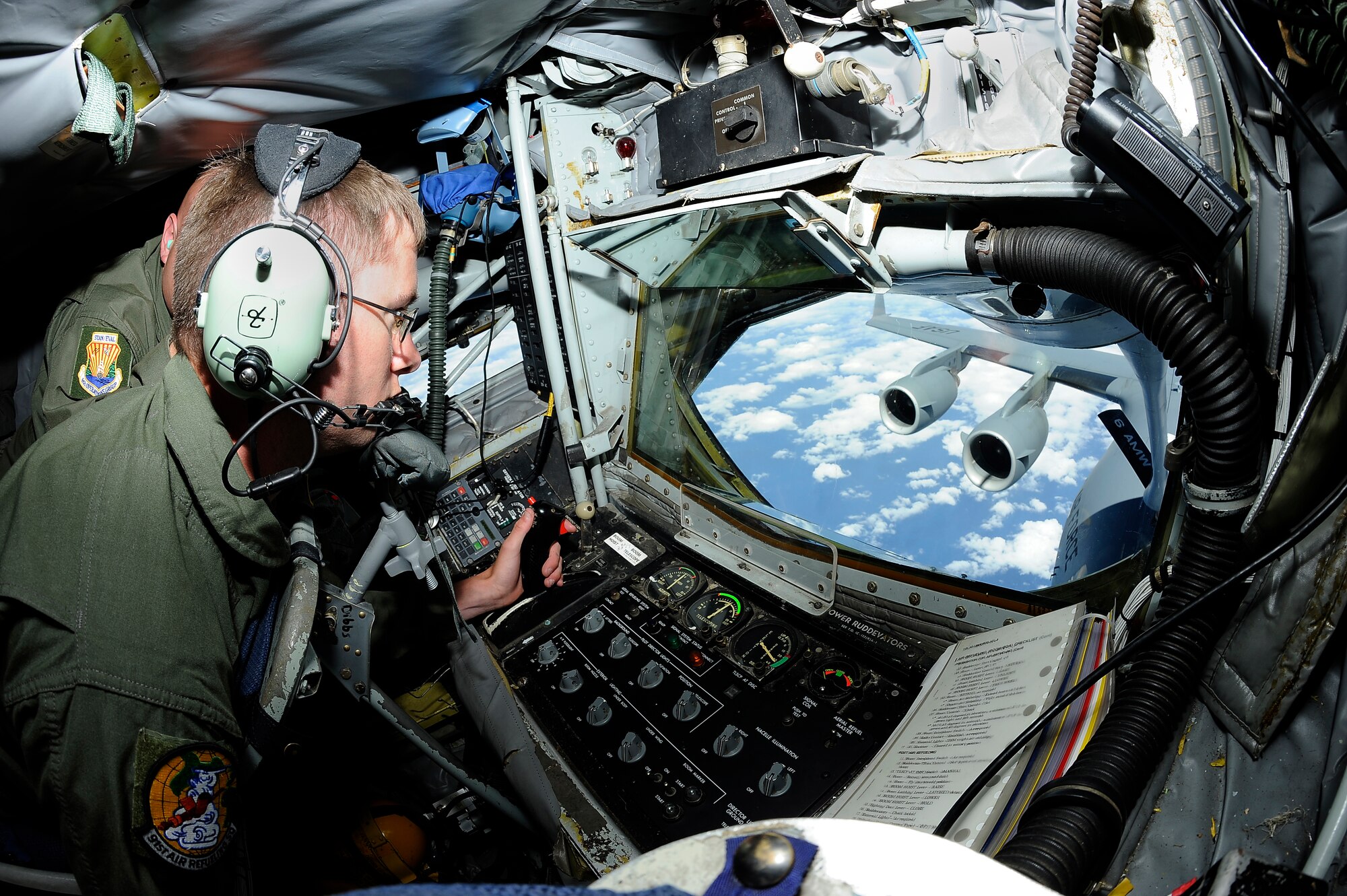 Airman 1st Class Michael McNicholas, a boom operator with the 91st Air Refueling Squadron, refuels a Boeing C-17 Globemaster III during a spouse familiarization flight off the East Coast, April 6, 2016. During the flight every spouse had an opportunity to watch the aerial refueling from the boom pod. (U.S. Air Force photo by Airman 1st Class Mariette Adams)