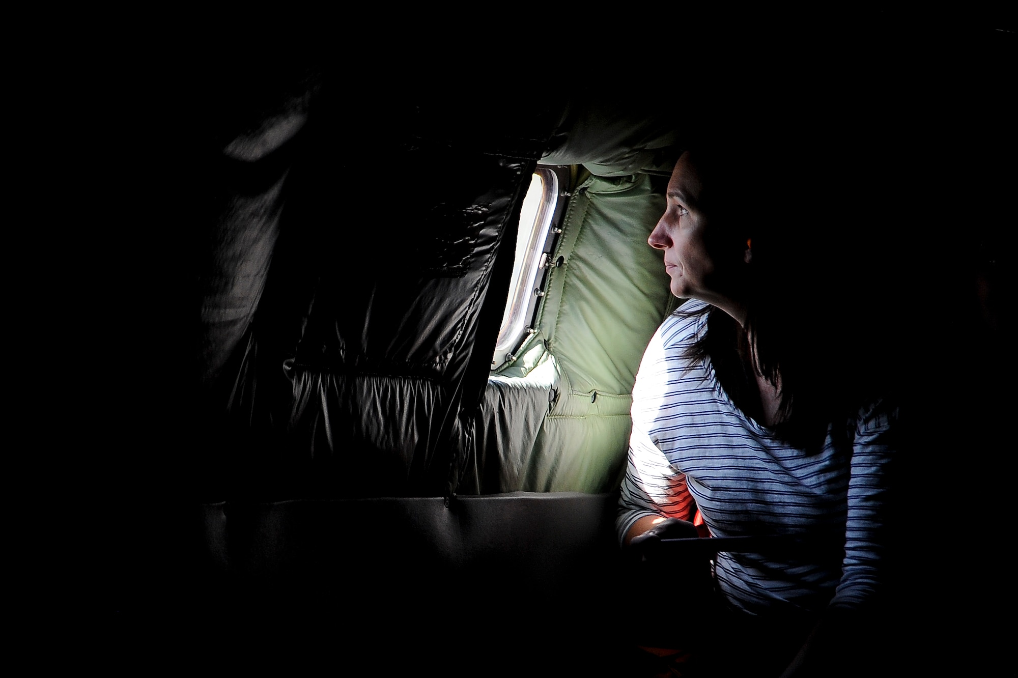 A military spouse looks out a KC-135 Stratotanker window during takeoff as part of a spouse familiarization flight at MacDill Air Force Base, Fla., April 6, 2016. During the flight, the spouses had a chance to ask questions and watch a C-17 Globemaster III being refueled from a KC-135’s boom pod. (U.S. Air Force photo by Airman 1st Class Mariette Adams)