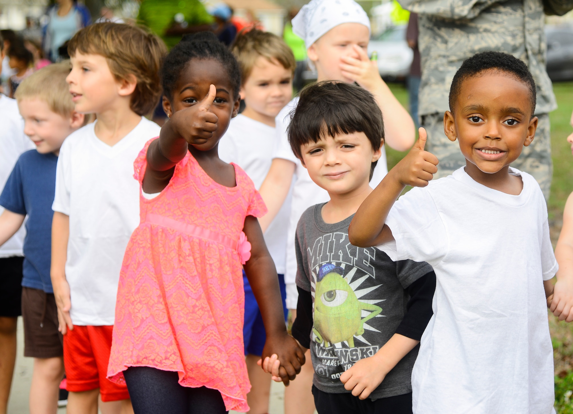 Children from the Child Development Center (CDC) at MacDill Air Force Base, Fla., give a thumbs up prior to participating in the first ever CDC Color Run, April 1, 2016. April is Month of the Military Child, which recognizes the challenges and sacrifices that military children make as their parents serve. (U.S. Air Force photo by Staff Sgt. Melanie Hutto)