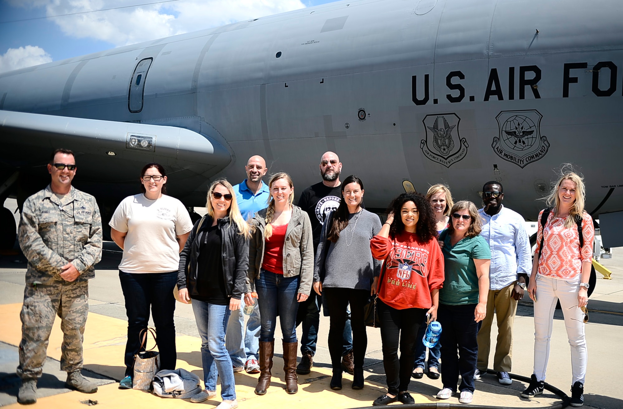 Military spouses pose in front of a KC-135 Stratotanker at MacDill Air Force Base, Fla., April 6, 2016. The 6th Air Mobility Wing hosted a spouse familiarization flight for 26 spouses from around the wing, the flight allowed them to witness the wing’s mission firsthand. (U.S. Air Force photo by Senior Airman Tori Schultz)