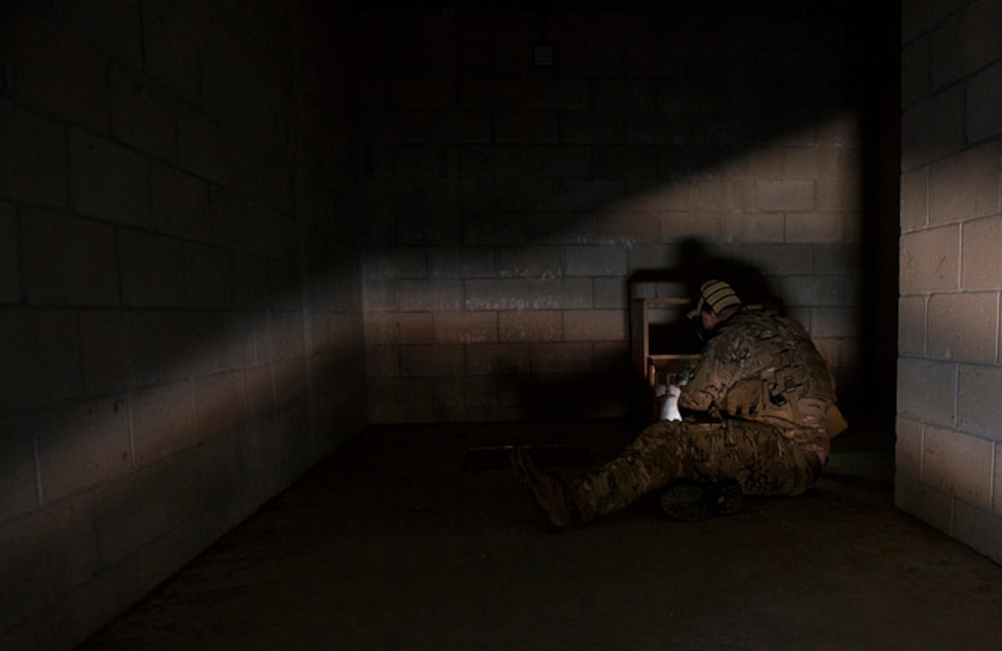 An explosive ordnance disposal technician examines a training improvised explosive device during Joint IED training on Joint Base McGuire-Dix-Lakehurst, N.J. March 29. Air Force and Marine Corps technicians from JB MDL, Dover Air Force Base, Delaware and Joint Base Langley-Eustis, Virginia participated in the training.