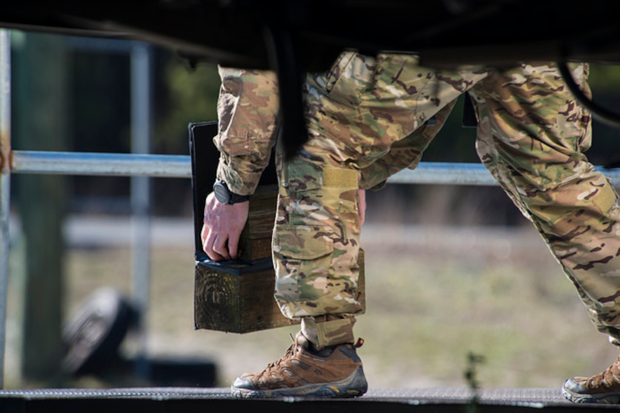 An explosive ordnance disposal technician picks up a piece of wood during Joint IED training on Joint Base McGuire-Dix-Lakehurst, N.J. March 29. Air Force and Marine Corps technicians from JB MDL, Dover Air Force Base, Delaware and Joint Base Langley-Eustis, Virginia participated in the training.