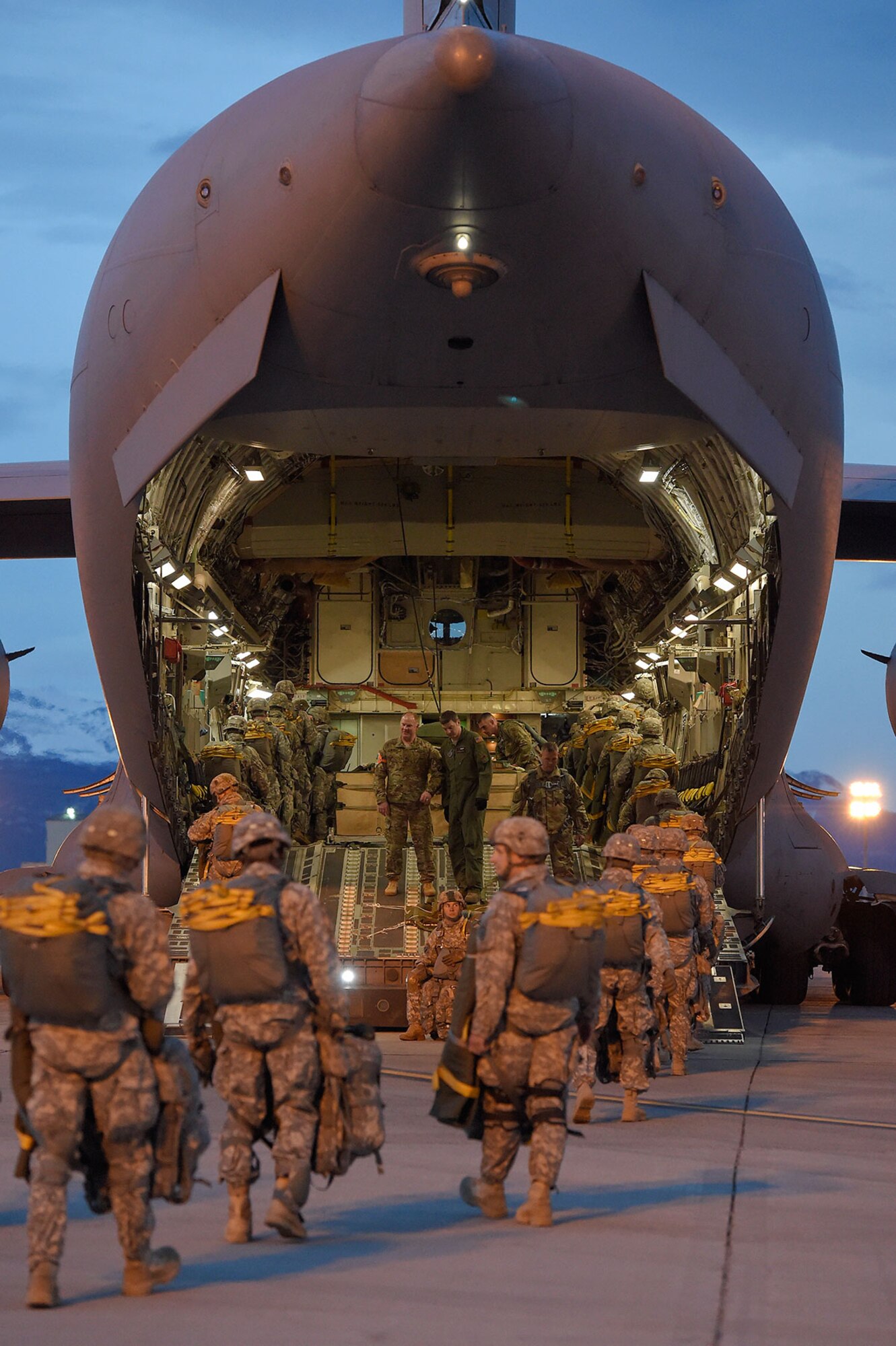 U.S. Army paratroopers assigned to the 4th Brigade Combat Team (Airborne), 25th Infantry Division, board a U.S. Air Force C-17 Globemaster III belonging to the 3rd Wing while conducting a night jump at Joint Base Elmendorf-Richardson, Alaska, March 31, 2016. The Soldiers of 4/25 belong to the only American airborne brigade in the Pacific and are trained to execute airborne maneuvers in extreme cold weather/high altitude environments in support of combat, partnership and disaster relief operations. (U.S. Air Force photo/Alejandro Pena)
