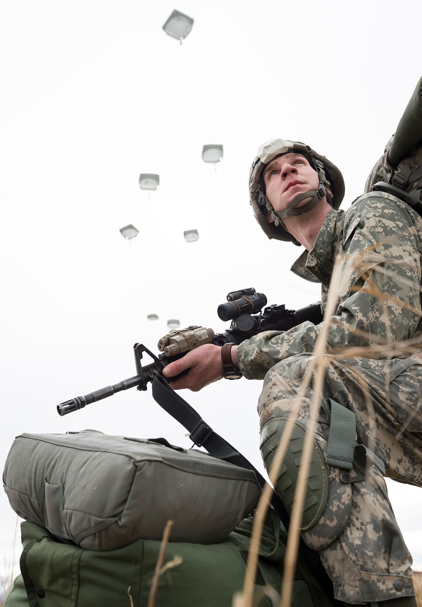 Spc. Nathan Lycan, a native of Los Angeles, assigned to Headquarters and Headquarters Company, 3rd Battalion (Airborne), 509th Infantry Regiment, 4th Brigade Combat Team (Airborne), 25th Infantry Division, U.S. Army Alaska, pulls security during a practice forced-entry parachute assault on Malemute drop zone at Joint Base Elmendorf-Richardson, Alaska, Tuesday, April 5, 2016. Having just successfully completed a rigorous evaluation at the Joint Readiness Training Center, the 4th Brigade Combat Team (Airborne), 25th Infantry Division is currently the most highly trained brigade combat team in the U.S. Army and is prepared to deploy globally at a moment's notice to execute combat, humanitarian assistance and/or disaster relief operations. (U.S. Air Force photo/Justin Connaher)