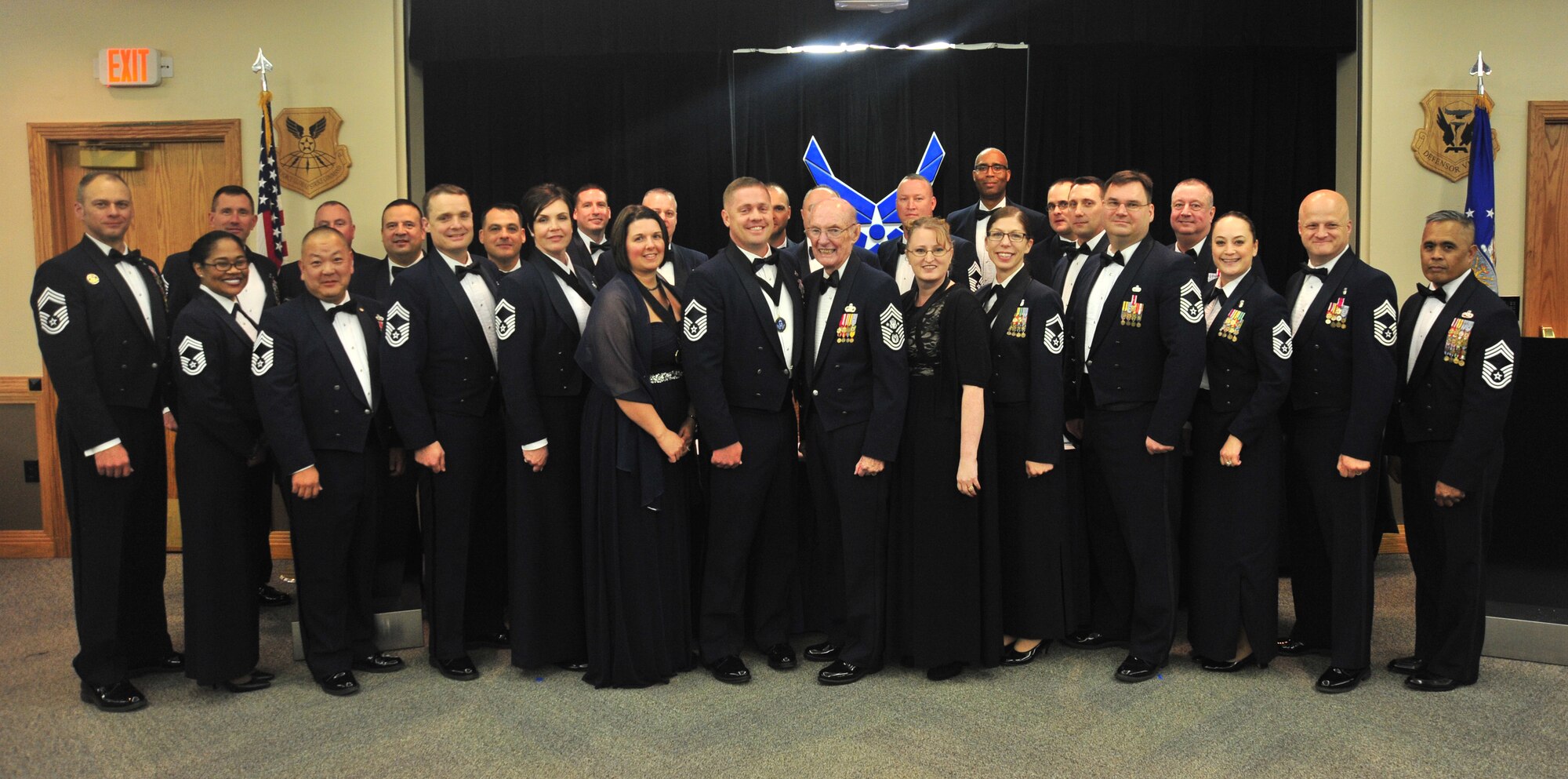 Members of Team whiteman gather for a group photo with Retired Chief Master Sgt. of the Air Force James McCoy to commemorate the promotion of the new chief master sergeants at Whiteman Air Force Base, Mo., April 1, 2016. Only one percent of the enlisted force is selected for promotion to chief master sergeant. (U.S., Air Force photo by Senior Airman Jovan D. Banks)