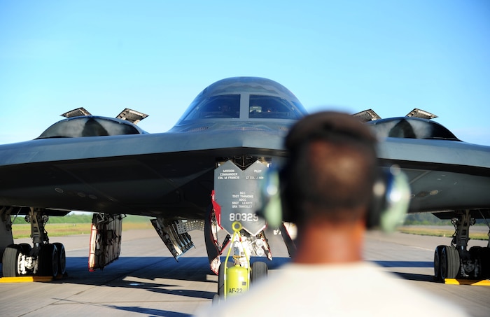 U.S. Air Force Senior Airman Hirantha De Mel, a crew chief with the 509th Aircraft Maintenance Squadron, watches a U.S. Air Force B-2 Spirit bomber perform an engine run, March 11, 2016, in the U.S. Pacific Command area of operations. Strategic Command bombers regularly deploy to the Indo-Asia-Pacific region to conduct PACOM-led operations which provide leaders deterrence options to maintain regional stability. (U.S. Air Force photo by Senior Airman Joel Pfiester/Released)