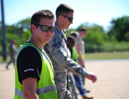 U.S. Air Force Airmen from Whiteman Air Force Base, Missouri, and the Royal Australian Air Force perform a foreign object debris walk at RAAF Base Tindal, Australia, March 22, 2016. The FOD walk was conducted during a training mission where a B-2 Spirit conducted an engine running crew change at the base. The B-2 was one of three that were deployed to the Indo-Asia-Pacific region from March 8 through 29 to enhance bomber crew readiness and proficiency and to integrate capabilities with key regional partners. U.S. Strategic Command bombers regularly rotate through the Indo-Asia-Pacific region to conduct theater security cooperation engagements with U.S. allies and partners and demonstrate a shared commitment to promoting security and stability in the region. (U.S. Air Force photo by Senior Airman Joel Pfiester/ Released)