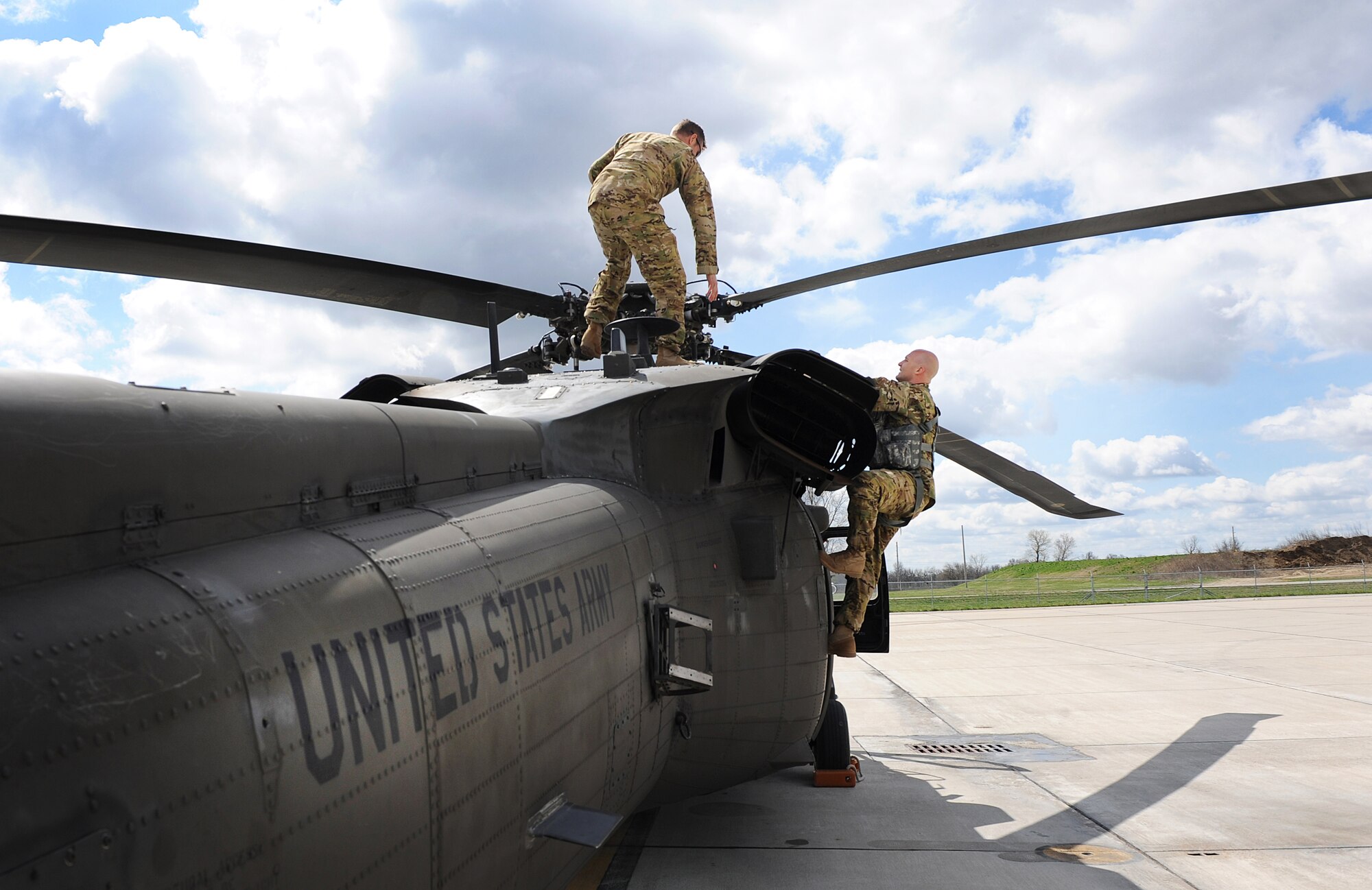 Missouri Army National Guard Chief Warrant Officer 4 Marcus Moore, a standardized instructor pilot, left, and Staff Sgt. Brandon Isabell, a crew chief, both assigned to the 1-135th Attack Reconnaissance Battalion (ARB) Army Aviation Support Facility #1, perform pre-takeoff inspections on a UH-60 Black Hawk at Whiteman Air Force Base, Mo., April 1, 2016. Due to the Department of the Army’s Aviation Reconstruction Initiative, nine AH-64 Apaches from the 1-135th ARB were moved to active-duty Army units across the country, and the 1-135th ARB received 10 Black Hawk helicopters. (U.S. Air Force photo by Airman 1st Class Michaela R. Slanchik)