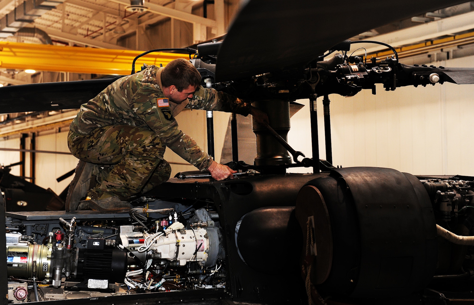Missouri Army National Guard Staff Sgt. Keith Neiman, a crew chief assigned to the 1-135th Attack Reconnaissance Battalion Army Aviation Support Facility #1, performs routine maintenance on a UH-60 Black Hawk utility helicopter at Whiteman Air Force Base, Mo., April 1, 2016. More than 90 enlisted aircraft maintainers, who previously only worked on the AH-64 Apache, are in the process of certifying to perform maintenance on Black Hawks following the helicopter’s recent arrival. (U.S. Air Force photo by Airman 1st Class Michaela R. Slanchik)