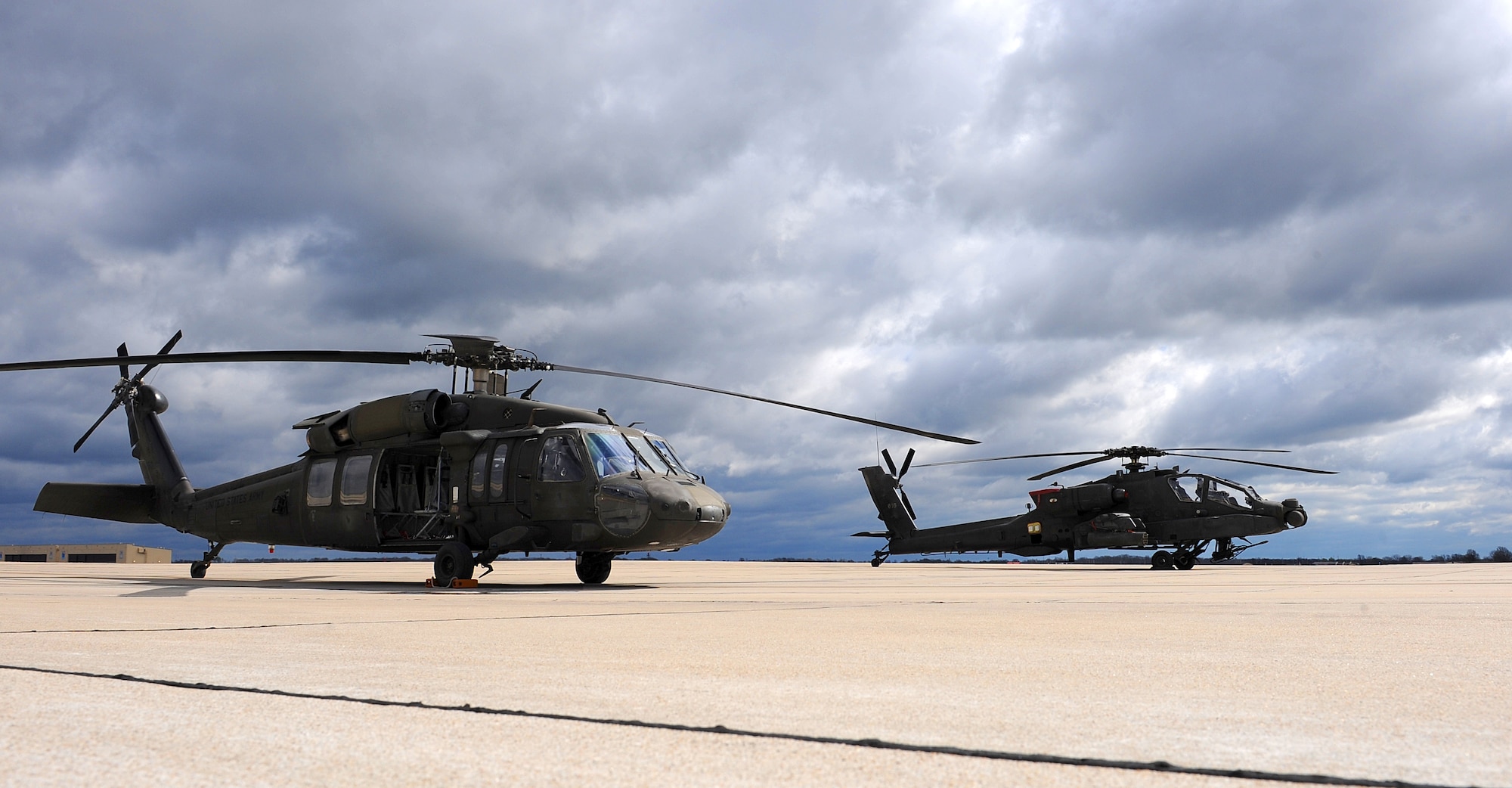 A Missouri Army National Guard UH-60 Black Hawk utility helicopter, left, sits next to an AH-64 Apache attack helicopter on the flightline at Whiteman Air Force Base, Mo., April 1, 2016. Black Hawk helicopters began arriving at the 1-135th Attack Reconnaissance Battalion in September of 2015 as part of the Department of the Army’s Aviation Reconstruction Initiative. There are now 13 Apaches and 10 Black Hawks assigned to the unit. (U.S. Air Force photo by Airman 1st Class Michaela R. Slanchik)